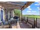 Spacious patio with a dining set and views of a green field and pergola with string lights at 3734 Ridgeway St, Boulder, CO 80301