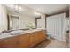 Bathroom with dual sinks, wooden cabinetry, and a large mirror for a functional and stylish space at 3734 Ridgeway St, Boulder, CO 80301
