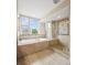 Well-lit bathroom featuring a soaking tub, glass shower, and neutral tiling for a clean aesthetic at 3734 Ridgeway St, Boulder, CO 80301