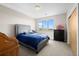 Bedroom with a cozy bed, a view of the outside, and ample storage space with dark furniture at 3734 Ridgeway St, Boulder, CO 80301