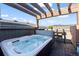 Relaxing hot tub on a private deck with a pergola and views of the surrounding landscape at 3734 Ridgeway St, Boulder, CO 80301