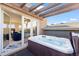 Relaxing hot tub on a private deck with a pergola and views of an indoor seating area at 3734 Ridgeway St, Boulder, CO 80301