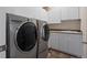 Well-equipped laundry room with modern washer and dryer, sink, and storage cabinets at 3734 Ridgeway St, Boulder, CO 80301