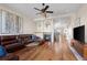 Cozy living room features a fireplace, ceiling fan and hardwood floors at 3734 Ridgeway St, Boulder, CO 80301
