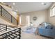 Comfortable living room featuring a stylish blue sofa, glass coffee table, and sleek staircase at 3734 Ridgeway St, Boulder, CO 80301