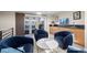 Comfortable sitting area with blue chairs, a wet bar, and sliding door access to an outdoor spa at 3734 Ridgeway St, Boulder, CO 80301