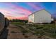 A spacious backyard with a wooden fence, grass, and potential gardening space perfect for outdoor enjoyment at 47300 Clover Ave, Bennett, CO 80102