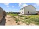 Large backyard featuring lawn, patio, garden beds, and play area, perfect for outdoor living and entertainment at 47300 Clover Ave, Bennett, CO 80102