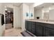 Bathroom featuring a double vanity with granite top, a walk-in closet and a shower at 47300 Clover Ave, Bennett, CO 80102