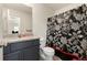 Bathroom featuring a vanity with granite top, toilet, and a shower with a decorative curtain at 47300 Clover Ave, Bennett, CO 80102