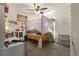 Bedroom featuring plush carpeting, a ceiling fan, natural light, and a comfortable four-poster bed at 47300 Clover Ave, Bennett, CO 80102