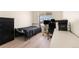 Bedroom featuring hardwood floors, natural light, a work station, and a single bed at 47300 Clover Ave, Bennett, CO 80102