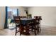 Cozy dining area with a wooden table set for eight and sliding glass doors leading to the backyard at 47300 Clover Ave, Bennett, CO 80102