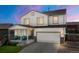 Charming two-story home showcasing a well-maintained lawn, inviting porch, and an attached two-car garage at 47300 Clover Ave, Bennett, CO 80102
