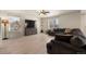 Bright living room featuring a ceiling fan, hardwood floors, and a comfortable sectional couch with natural light at 47300 Clover Ave, Bennett, CO 80102