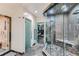 Luxurious glass shower with stone tiling and a bench, inside a custom home gym and sauna at 2635 Spruce Meadows Dr, Broomfield, CO 80023