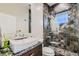 Modern bathroom with a vessel sink, tiled shower, and contemporary fixtures at 2635 Spruce Meadows Dr, Broomfield, CO 80023