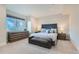 Bedroom with tufted headboard, bench, and many windows for natural light at 2635 Spruce Meadows Dr, Broomfield, CO 80023