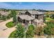 Stunning home features landscaped grounds, a spacious patio, and a charming exterior design at 2635 Spruce Meadows Dr, Broomfield, CO 80023