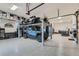 Spacious garage featuring a vehicle lift, tool storage, and ample room for multiple cars at 2635 Spruce Meadows Dr, Broomfield, CO 80023