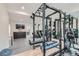 Spacious home gym featuring a treadmill, weight rack with free weights and mirrored wall at 2635 Spruce Meadows Dr, Broomfield, CO 80023