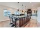 Gourmet kitchen with a large island, barstool seating, custom cabinetry, and modern lighting at 2635 Spruce Meadows Dr, Broomfield, CO 80023