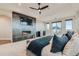 Bright main bedroom featuring a fireplace, TV, ceiling fan and a balcony with a neighborhood view at 2635 Spruce Meadows Dr, Broomfield, CO 80023