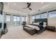 Spacious main bedroom boasts a trey ceiling, ceiling fan, exterior views, and a sitting area at 2635 Spruce Meadows Dr, Broomfield, CO 80023