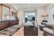 Well-lit office featuring a modern desk, built-in storage, and a comfortable seating area at 2635 Spruce Meadows Dr, Broomfield, CO 80023