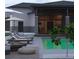 Modern pool with lounge chairs and sleek stone accents complements the home's exterior at 2635 Spruce Meadows Dr, Broomfield, CO 80023