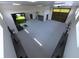 Spacious room with golf simulator, exercise equipment, and ample space for recreational activities at 2635 Spruce Meadows Dr, Broomfield, CO 80023