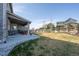Spacious backyard features a covered patio, seating, and a wood fence at 12659 Stone Creek Ct, Firestone, CO 80504