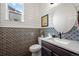 Stylish powder room features a shiplap wall and decorative tile at 12659 Stone Creek Ct, Firestone, CO 80504