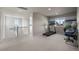 Upstairs bonus room with carpet, treadmill and bright windows at 12659 Stone Creek Ct, Firestone, CO 80504