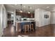 Modern kitchen boasts dark cabinets, a blue kitchen island, and pendant lighting at 12659 Stone Creek Ct, Firestone, CO 80504
