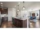 Lovely kitchen with marble countertop island, stainless appliances, and access to dining and stairs at 12659 Stone Creek Ct, Firestone, CO 80504