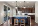 Bright kitchen features a large island with seating and stainless steel appliances at 12659 Stone Creek Ct, Firestone, CO 80504