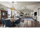 Open concept living and dining room featuring hardwood floors and modern lighting at 12659 Stone Creek Ct, Firestone, CO 80504