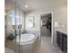 Spa-like primary bath with soaking tub, separate shower, and walk-in closet at 12659 Stone Creek Ct, Firestone, CO 80504