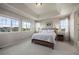 Large main bedroom featuring neutral walls, tray ceiling, and large windows for natural light at 12659 Stone Creek Ct, Firestone, CO 80504