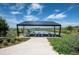 Outdoor seating area overlooking the water, providing a serene spot for relaxation and enjoying the community's natural beauty at 12659 Stone Creek Ct, Firestone, CO 80504