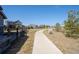 A beautiful walking path with lush green landscaping provides a serene and peaceful escape at 12659 Stone Creek Ct, Firestone, CO 80504