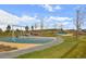 A colorful playground with swings, slides, and a walking path for families to enjoy outdoor recreation and fun at 12659 Stone Creek Ct, Firestone, CO 80504