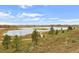 Relaxing view of the neighborhood pond, with winding walking trails, creating a serene atmosphere at 12659 Stone Creek Ct, Firestone, CO 80504