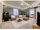 Cozy basement living room with ambient string lights and a sleek kitchenette at 26293 E Archer Ave, Aurora, CO 80018