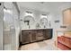Elegant primary bathroom featuring double vanities, modern lighting, and a tiled shower at 26293 E Archer Ave, Aurora, CO 80018