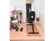 Bonus room features workout equipment, mirror, storage cube with baskets, weights, and accessories at 26293 E Archer Ave, Aurora, CO 80018