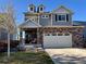 Charming two-story home featuring stone accents, neutral siding, dormer windows, and an attached two-car garage at 26293 E Archer Ave, Aurora, CO 80018