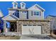 Charming two-story home featuring a stone facade, neutral siding, and a two-car garage at 26293 E Archer Ave, Aurora, CO 80018