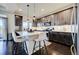 Modern kitchen features stainless appliances, a center island with chairs, and lots of cabinet storage at 26293 E Archer Ave, Aurora, CO 80018